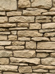 Fototapeta premium Natural rustic stacked stone wall texture background with rough surface and varying shades of grey and brown, stacked, texture