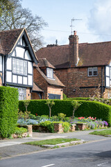 Walking on streets of North London, red brick houses and flowering gardens in spring, city life, wealthy neighbourhoods in London, UK