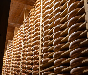 Aging rooms with shelves in cheese caves, central location for aging of wheels, rounds of Comte cheese from four months to several years made from raw cow milk, Jura, France