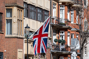 National flag of the United Kingdom is the Union Jack, also known as the Union Flag on houses in central London, UK