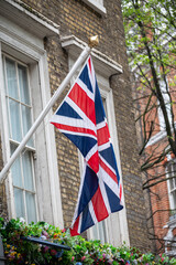 National flag of the United Kingdom is the Union Jack, also known as the Union Flag on houses in central London, UK
