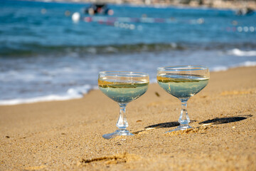 Summer time on French Riviera, two coupe glasses of champagne cremant sparkling wine on Pampelonne...