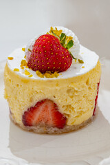 Red fruit sweet dessert cheesecake tart with fresh strawberries in bakery