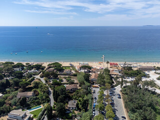 Fototapeta premium Aerial view on boats, crystal clear blue water of Plage du Debarquement white sandy beach near Cavalaire-sur-Mer and La Croix-Valmer, summer vacation on French Riviera, Var, France