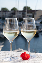 Glasses of cold white Cote de Provence wine in yacht harbour of Port Grimaud, summer vacation on French Riviera in Provence, France, wine tasting