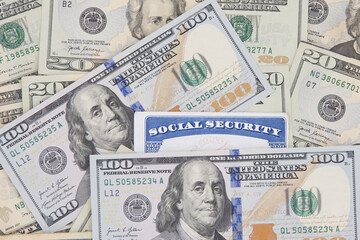 Social Security card with 20 and 100 dollar bills. SS number is a nine digit number issued to U.S. Citizens and is required to legally be employed in the United States
