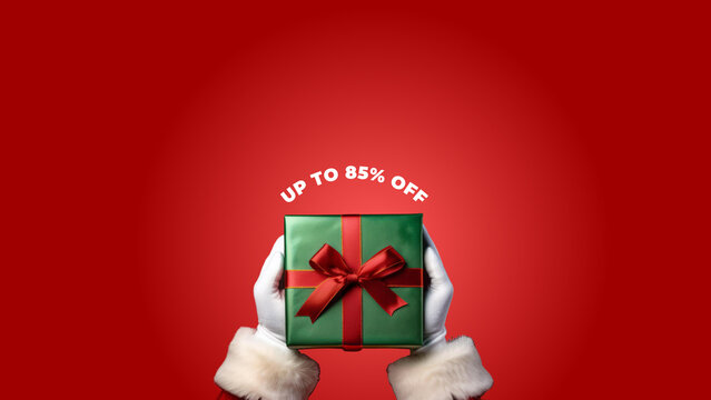 papai noel segurando pacote de presente escrito "UP TO 85% OFF"
