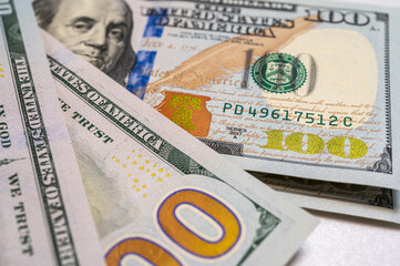 Close-up view of a 100 dollar bill with details, texture and vibrant colors. Perfect for finance, banking and wealth themes, vertical photo, wallpaper	
