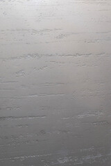 Close-up of a textured plaster surface revealing a minimalist concrete look