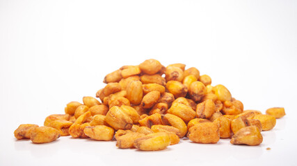 Roasted corn kernels piled on a white surface ready for snacking and cooking