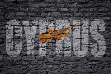 painted national flag with text cyprus on a old brick wall