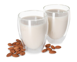 Glasses of almond milk and nuts isolated on white