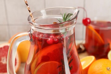 Delicious punch with rosemary in jug, closeup
