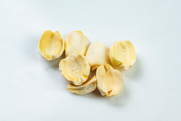 Closeup view of lotus seeds (Nelumbo nucifera) on a white background