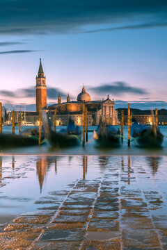 Gondolas at dawn with high tide, Venice, Italy