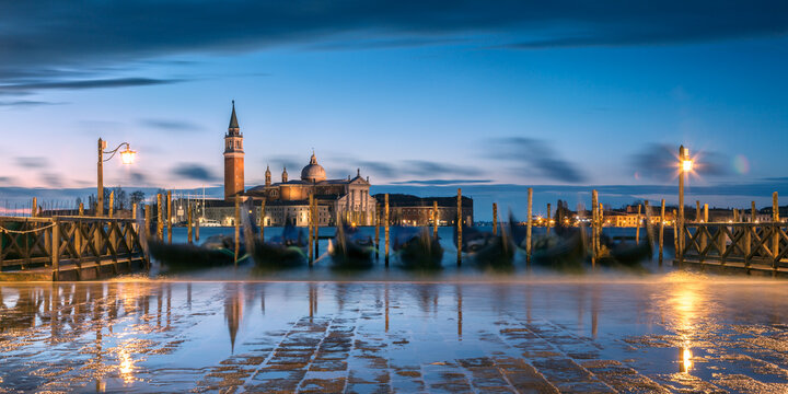 Gondolas at dawn with high tide, Venice, Italy
