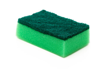 Cleaning sponge resting on a white surface, showcasing its vibrant green and soft texture for effective use