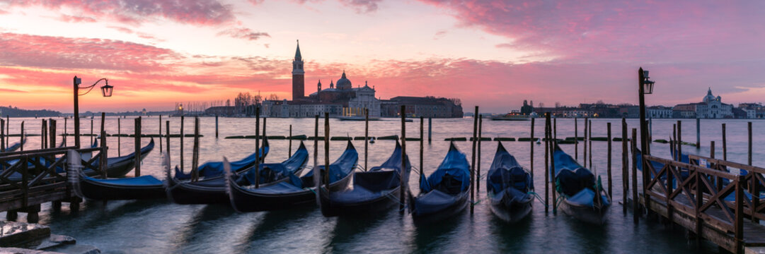 Panoramic of gondolas moored near San Marco at sunrise, Venice, Italy