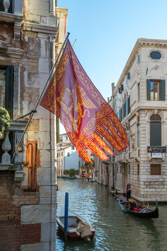 Gondola on canal and venetian flag, Venice, Veneto, Italy