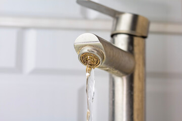 Dirty faucet with water stains.