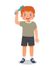 cute little boy combing his hair with comb
