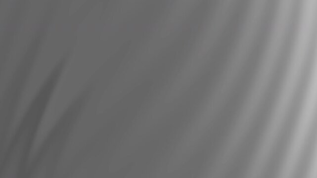 Gray background with blurry light gray leaf shadows is suitable for naturethemed designs or backgrounds for printed materials.