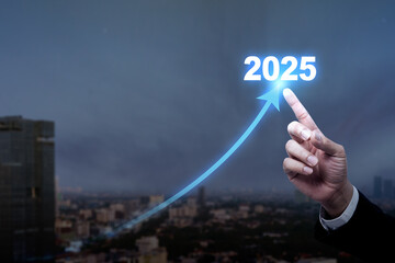 Businessman hand pointing an increased arrow of 2025. Planning, opportunity, challenge, and business strategy