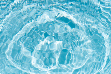Blue water with ripples on the surface. Defocus blurred transparent blue colored clear calm water...