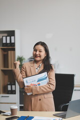 Young business woman having .happy at the desk in the office