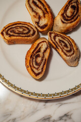 five Kleicha, Iraqi date cookies in spiral form on plate