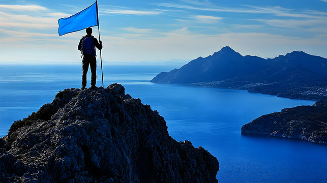 Climber Plants Blue Flag on Mountain Peak Overlooking Sea - Powered by Adobe