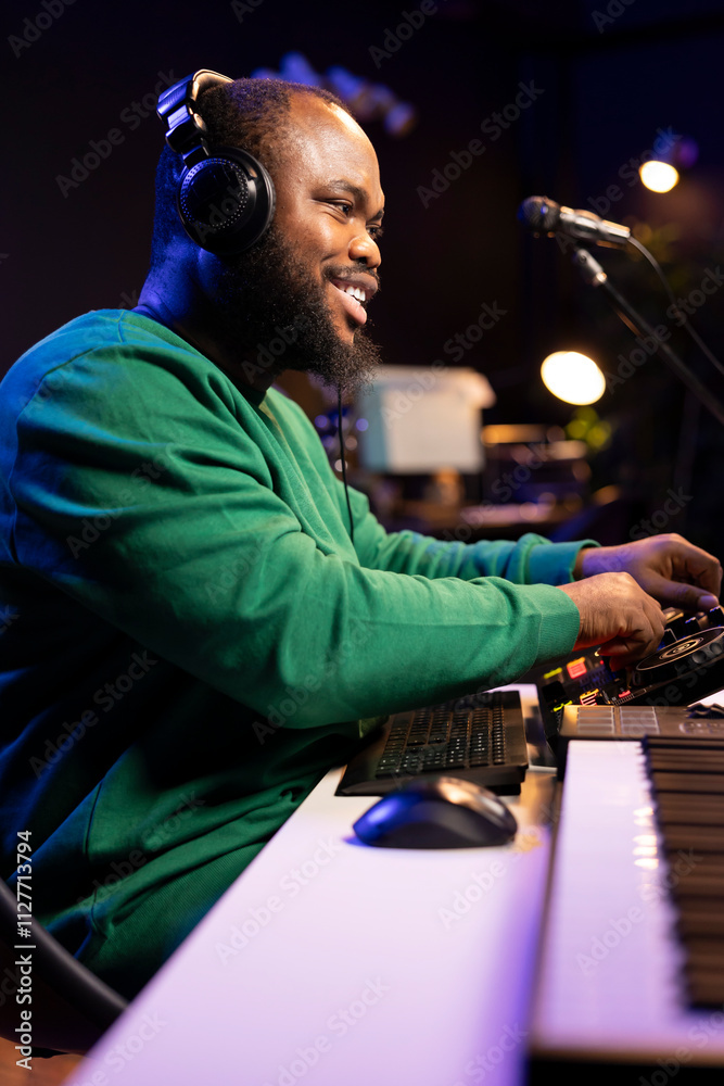 Leinwandbilder audio engineer with headset mixing and mastering his recorded files, operating on a professional sou
