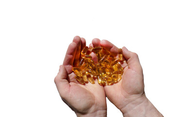 Fototapeta premium Omega fatty acids jelly capsules in hands on white background. Fish oil gelatin capsules.Dietary supplements and vitamins in nutrition.Healthy fats 