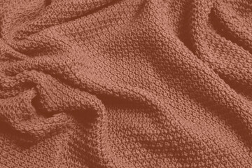 Mocha Mousse toned colour monochrome texture knitted fabric. Knitted Jersey as textile background. Monochrome color background. Wool knitting texture. Trendy color 2025.
