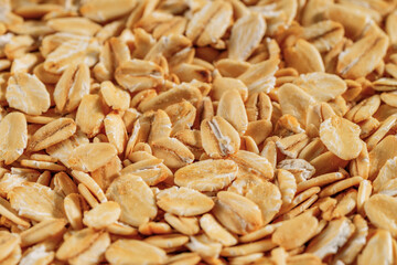 Close-up view of rolled oats texture, ideal for backgrounds and healthy food themes.