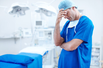 Sad, surgery and stress with man in hospital for patient loss, healthcare and frustrated. Medical...