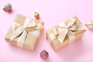 Christmas balls and gift boxes on pink background