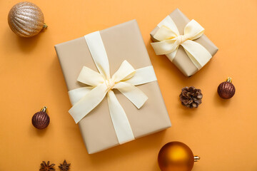 Christmas balls and gift boxes on orange background