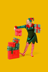 Beautiful young woman dressed as elf with Christmas gifts on yellow background