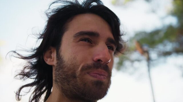 Long Hair Man Chews Sour Lemon and Makes Disgusted Facial Expressions Outdoors
