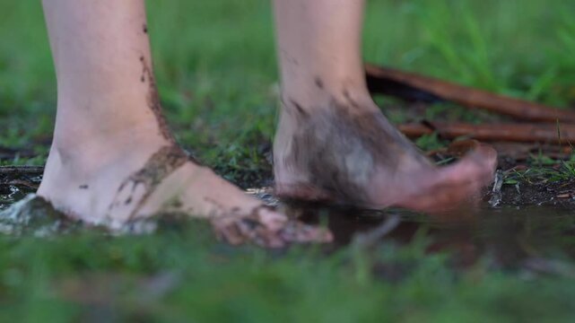 Barefoot woman standing in a puddle in the rain. Emphasizing grounding, connection to nature, and eco-conscious living. Perfect for themes of sustainability, wellness, harmony, and mindfulness.