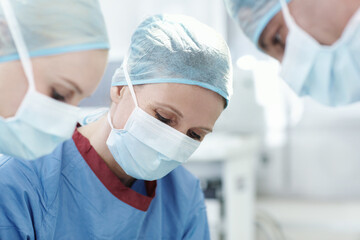 People, mask or surgeons in operation for surgery, emergency accident or healthcare in hospital theatre. Medical, clinic or doctors in surgical scrubs in operating room for teamwork, cutting or help
