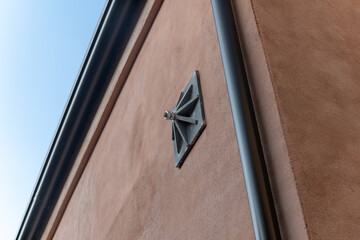 Tie rod on exposed building wall on the facade of the building, with construction detail of the support keys of the internal tie rods, key - counter-thrust chain for a renovated building. detail