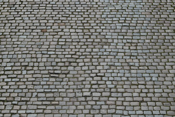 Background of cobblestone. Architecture background with stone cladding road. Concrete tiles background. Stone road background for poster or banner.