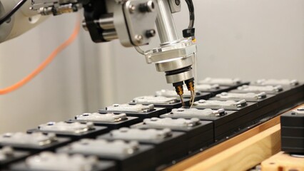 A robotic arm delicately assembling personalized gadgets using precise movements to fit each customized component seamlessly together.