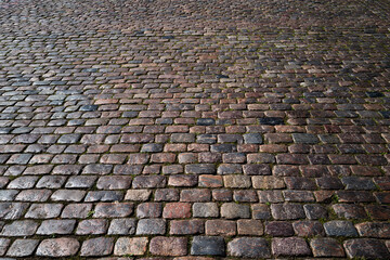 Pavement road. Stone cladding. Rough brick road. Cobblestone pavement background. Textured...