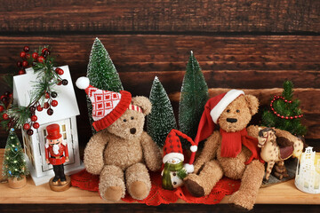 Christmas decoration with two teddy bears sitting on wooden shelf