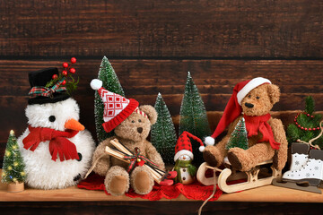 Wooden shelf with Christmas decorations, teddy bears and snowman