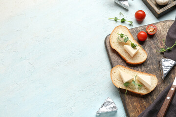 Composition with triangles of tasty processed cheese, bread and tomatoes on light background