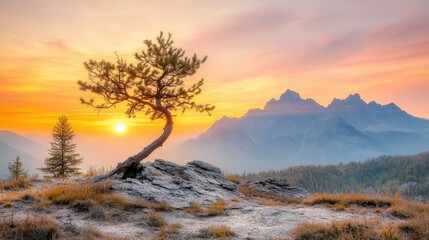 The sun dips below the jagged peaks, casting a warm golden glow over the rugged landscape